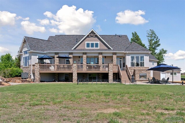 3048 Deer Creek Ranch Loop, Parker, CO 80138 - rear view of house with stone siding, a wooden deck, a lawn, a patio area, and stairway