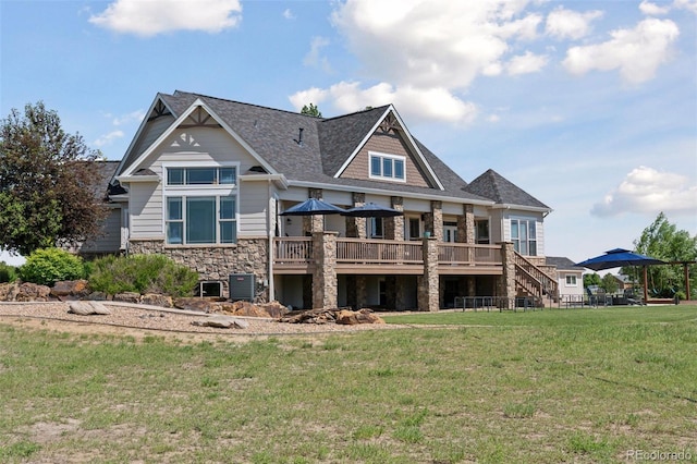 3048 Deer Creek Ranch Loop, Parker, CO 80138 - rear view of house with stone siding, a deck, a yard, and a shingled roof