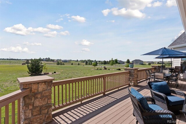 3048 Deer Creek Ranch Loop, Parker, CO 80138 - wooden terrace with outdoor dining area, a lawn, and a view of countryside