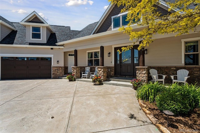 3048 Deer Creek Ranch Loop, Parker, CO 80138 - view of front of home with covered porch, stone siding, driveway, roof with shingles, and a garage