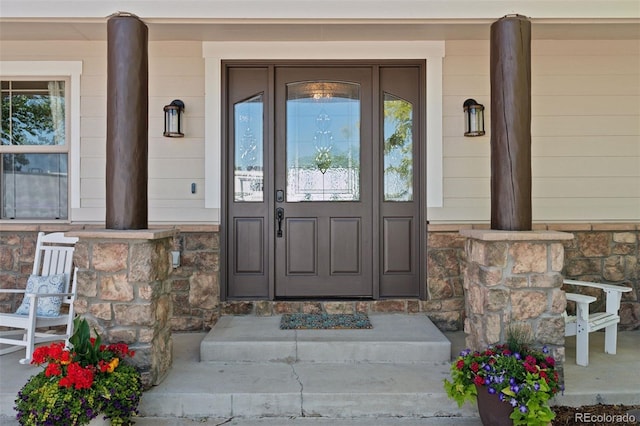 3048 Deer Creek Ranch Loop, Parker, CO 80138 - doorway to property featuring covered porch and stone siding