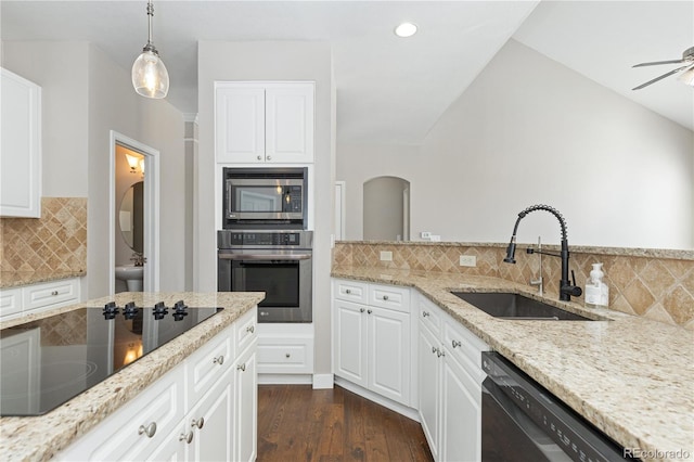 kitchen featuring white cabinets, light stone countertops, sink, and black appliances