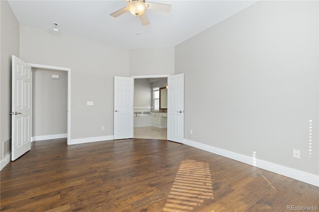 unfurnished bedroom with hardwood / wood-style flooring, connected bathroom, and ceiling fan