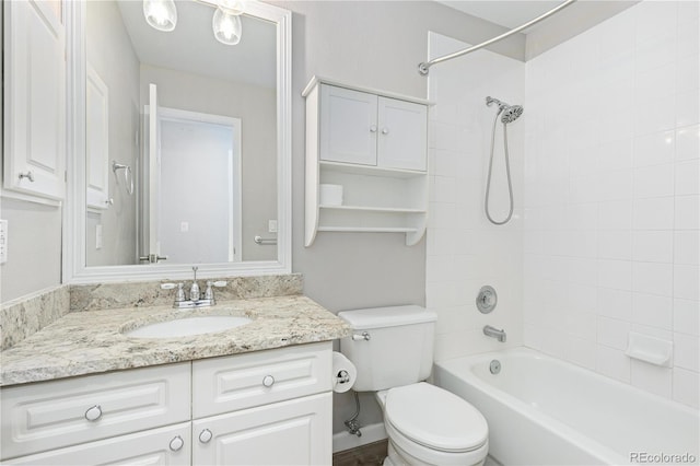 full bathroom with tiled shower / bath combo, vanity, and toilet