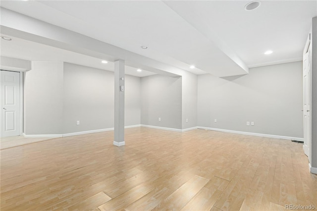 basement with light hardwood / wood-style floors