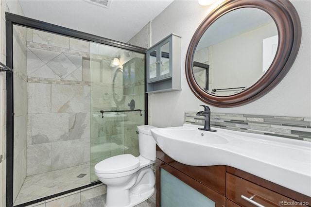 bathroom featuring vanity, toilet, and walk in shower