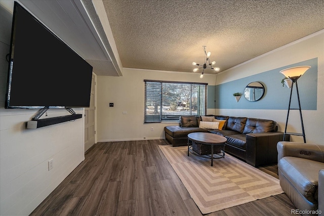 living room featuring dark hardwood / wood-style floors, a textured ceiling, and an inviting chandelier