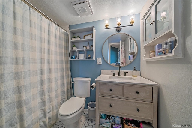 bathroom with vanity, toilet, curtained shower, and a textured ceiling