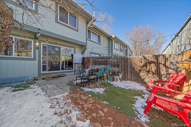 yard layered in snow featuring a patio area