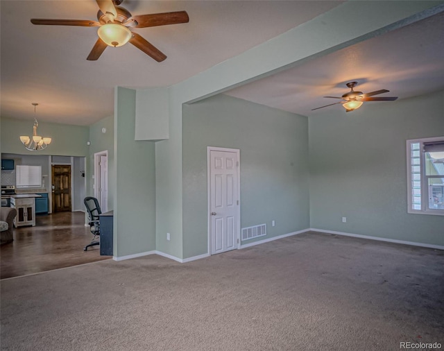 carpeted empty room with ceiling fan with notable chandelier