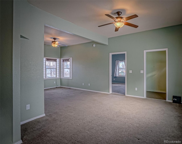 unfurnished room featuring beamed ceiling, ceiling fan, and carpet flooring