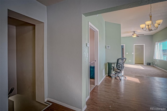 hallway featuring hardwood / wood-style floors and a chandelier