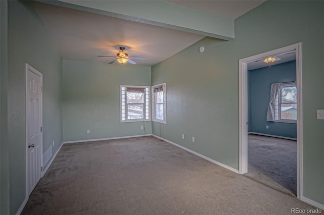 unfurnished room featuring beamed ceiling, light carpet, and ceiling fan