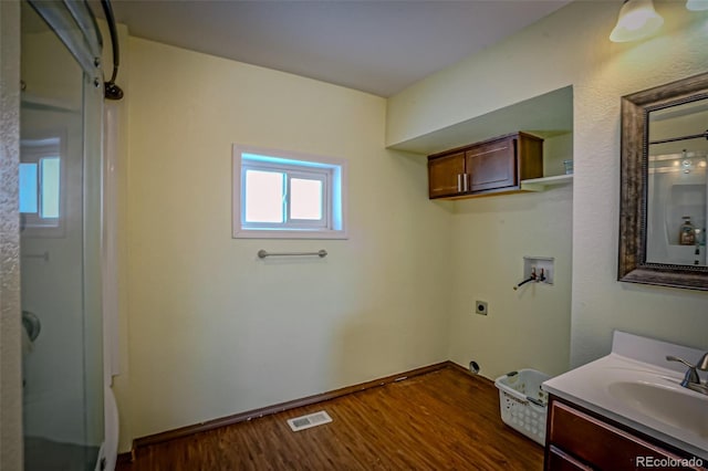 bathroom featuring vanity, wood-type flooring, and walk in shower