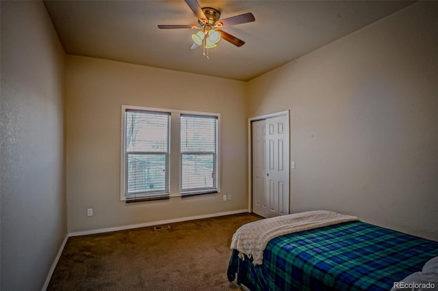 carpeted bedroom featuring ceiling fan and a closet