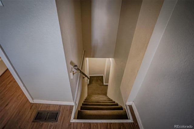 stairway with hardwood / wood-style flooring