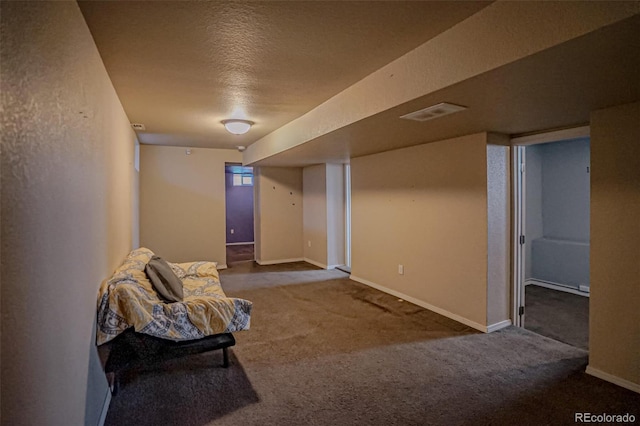 interior space featuring carpet floors and a textured ceiling