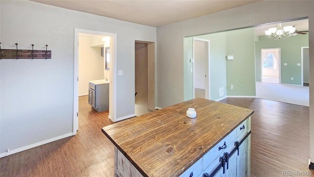 1205 N Linden Ave, Trinidad, CO 81082 - kitchen with light wood finished floors, a chandelier, and a center island