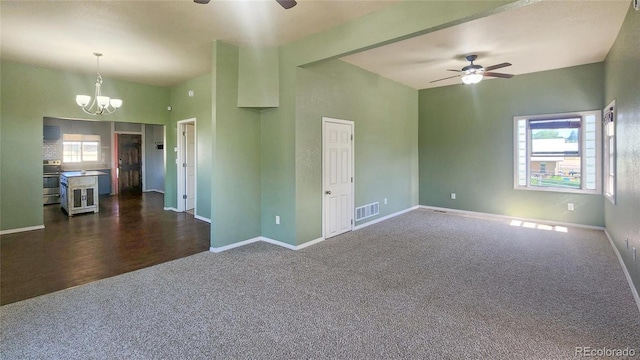 1205 N Linden Ave, Trinidad, CO 81082 - unfurnished living room featuring a ceiling fan, dark carpet, plenty of natural light, and a chandelier
