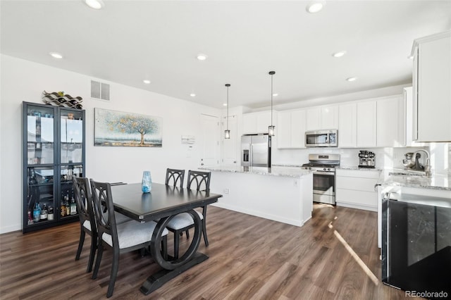 dining room with dark hardwood / wood-style floors and sink