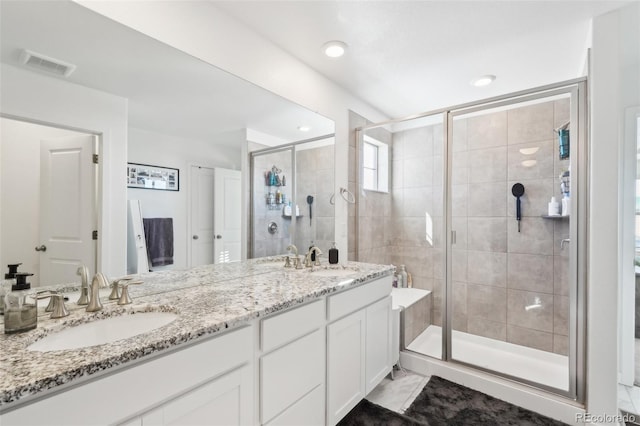 bathroom featuring vanity and a shower with shower door