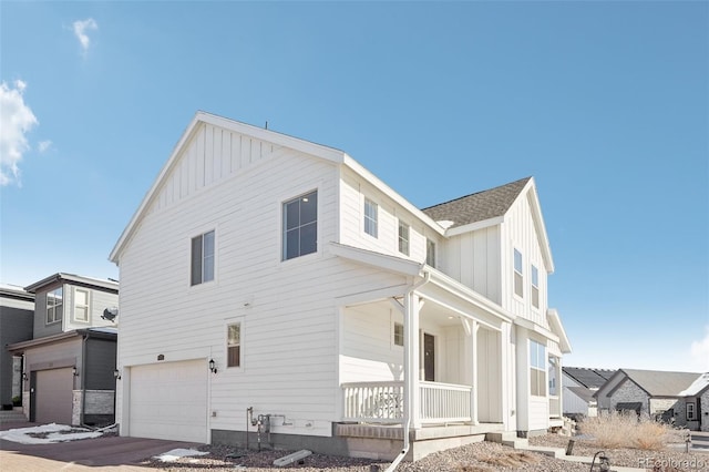 exterior space featuring a porch and a garage