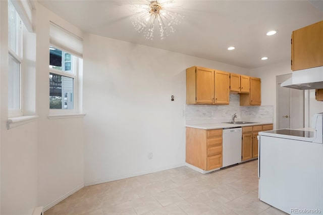 kitchen featuring range hood, a notable chandelier, white dishwasher, washer / clothes dryer, and light brown cabinetry