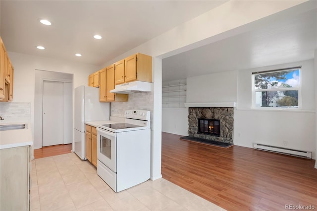 kitchen with light brown cabinets, baseboard heating, backsplash, white appliances, and light wood-type flooring