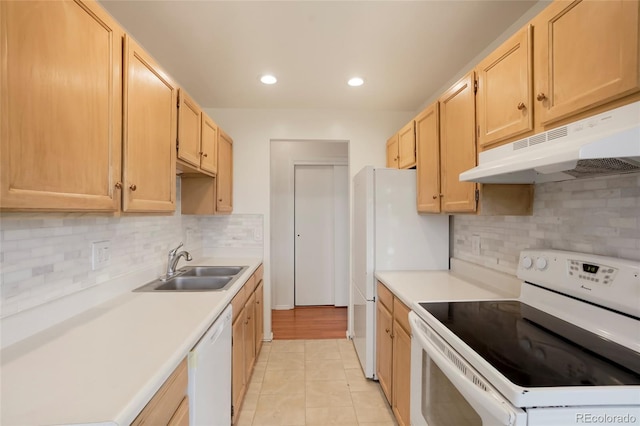 kitchen featuring backsplash, light tile patterned floors, light brown cabinetry, sink, and white appliances