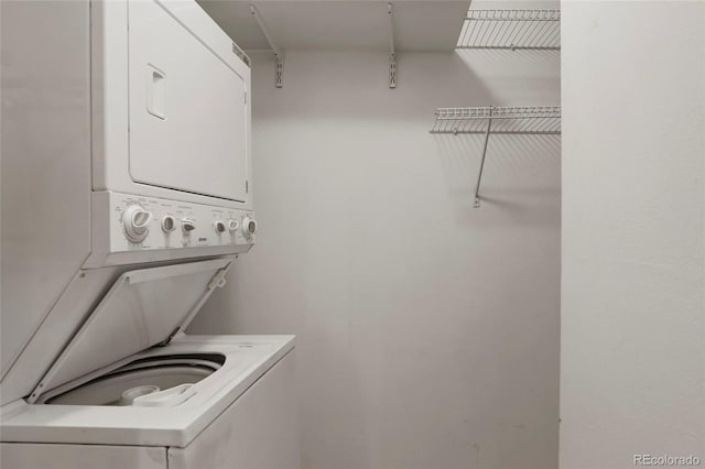 washroom featuring stacked washing maching and dryer