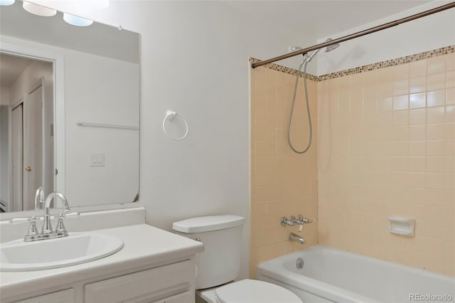 full bathroom featuring toilet, tiled shower / bath combo, and vanity