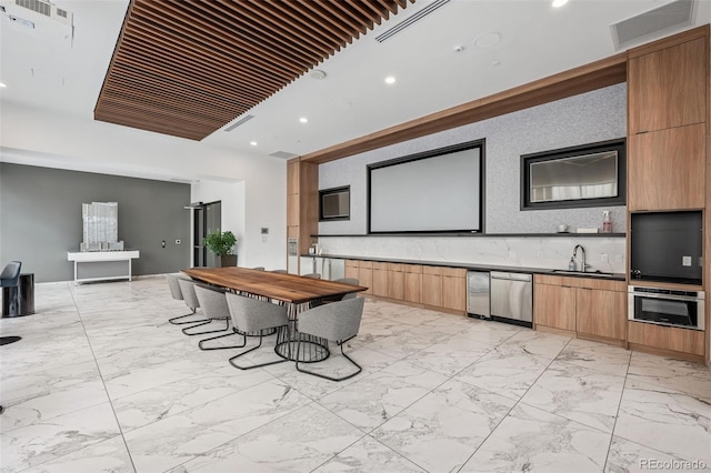 interior space featuring appliances with stainless steel finishes, marble finish floor, recessed lighting, and modern cabinets