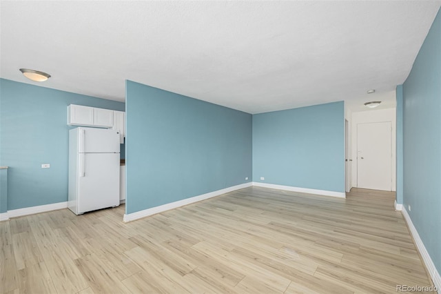 1196 N Grant St Unit 705, Denver, CO 80203 - unfurnished room with baseboards and light wood-style flooring