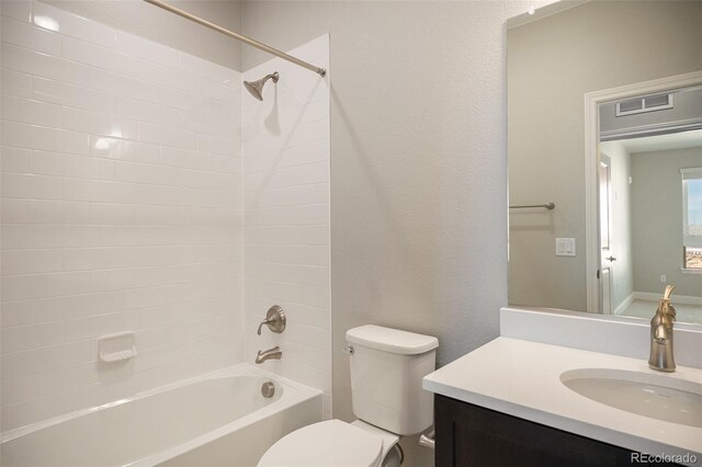 full bathroom featuring vanity, toilet, and tiled shower / bath