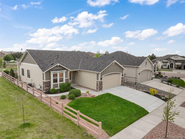 6015 Trappers Tale Ct, Colorado Springs, CO 80923 - view of front of house with a shingled roof, stone siding, an attached garage, driveway, and board and batten siding