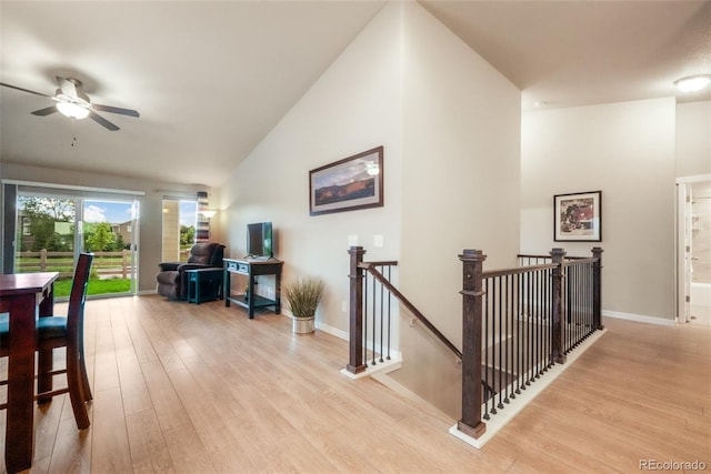 6015 Trappers Tale Ct, Colorado Springs, CO 80923 - corridor featuring an upstairs landing, light wood finished floors, vaulted ceiling, and baseboards