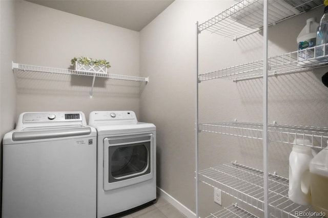 6015 Trappers Tale Ct, Colorado Springs, CO 80923 - laundry area featuring independent washer and dryer, baseboards, and light tile patterned flooring