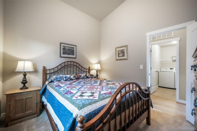 6015 Trappers Tale Ct, Colorado Springs, CO 80923 - bedroom with washer / clothes dryer, lofted ceiling, and light carpet