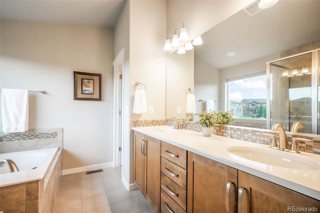 6015 Trappers Tale Ct, Colorado Springs, CO 80923 - full bathroom featuring double vanity, a garden tub, tile patterned floors, and baseboards