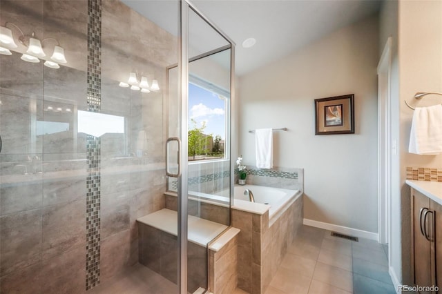 6015 Trappers Tale Ct, Colorado Springs, CO 80923 - full bath with a bath, a shower stall, vanity, tile patterned floors, and lofted ceiling