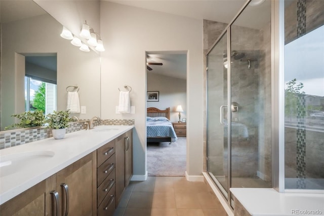 6015 Trappers Tale Ct, Colorado Springs, CO 80923 - ensuite bathroom with tile patterned floors, double vanity, ceiling fan, a stall shower, and baseboards