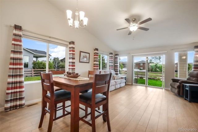 6015 Trappers Tale Ct, Colorado Springs, CO 80923 - dining space featuring lofted ceiling, light wood finished floors, a ceiling fan, baseboards, and a chandelier