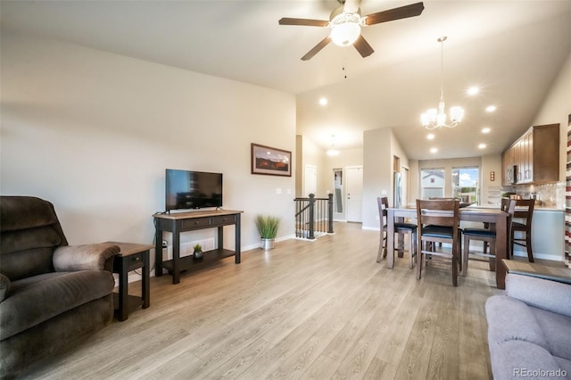 6015 Trappers Tale Ct, Colorado Springs, CO 80923 - living room with ceiling fan, light wood finished floors, baseboards, a chandelier, and high vaulted ceiling