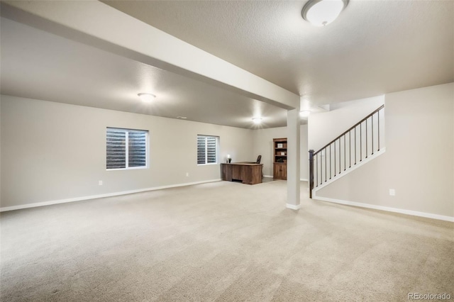 6015 Trappers Tale Ct, Colorado Springs, CO 80923 - unfurnished living room featuring baseboards, carpet flooring, and stairs
