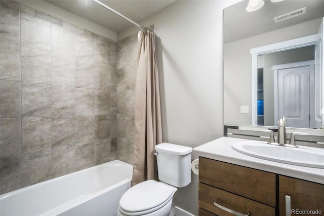 6015 Trappers Tale Ct, Colorado Springs, CO 80923 - bathroom featuring toilet, vanity, shower / tub combo with curtain, and a textured wall