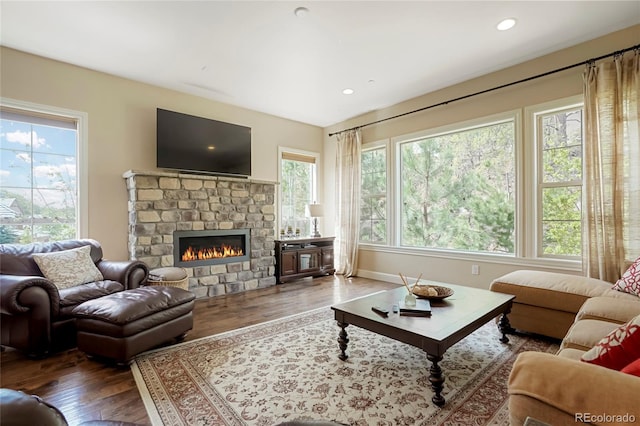 living room with wood finished floors, a fireplace, recessed lighting, and baseboards