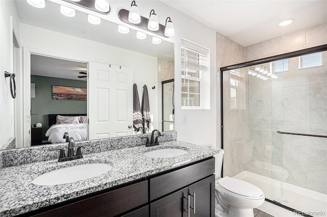 full bathroom featuring a stall shower, a sink, and ensuite bathroom