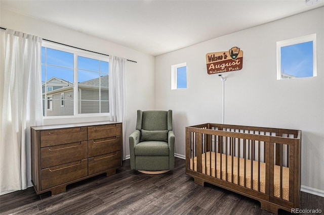 bedroom with dark wood-type flooring, multiple windows, and baseboards