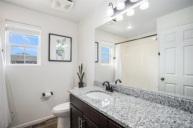 bathroom with visible vents, a shower with shower curtain, toilet, wood finished floors, and baseboards