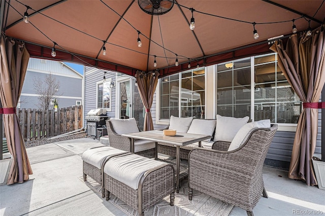 view of patio with fence, an outdoor living space, area for grilling, and a gazebo